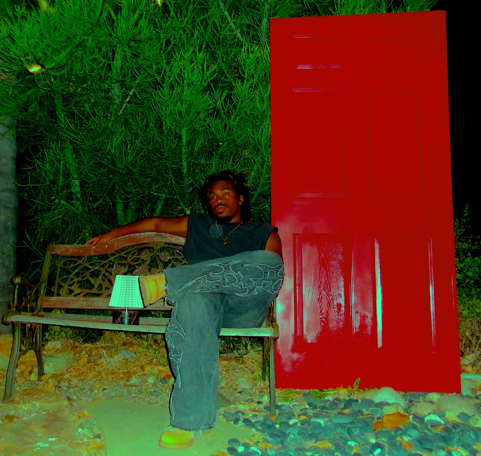 Shalant in a green-lit scene beside the red door
