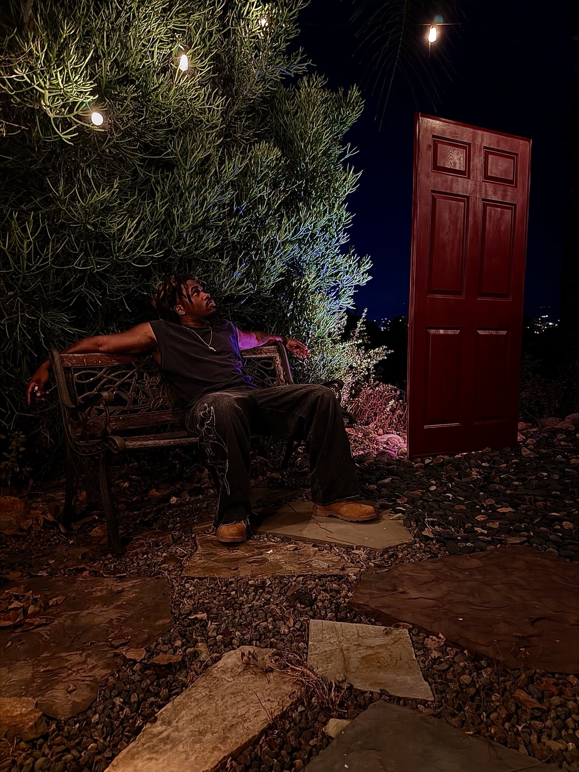 Shalant seated near the red door