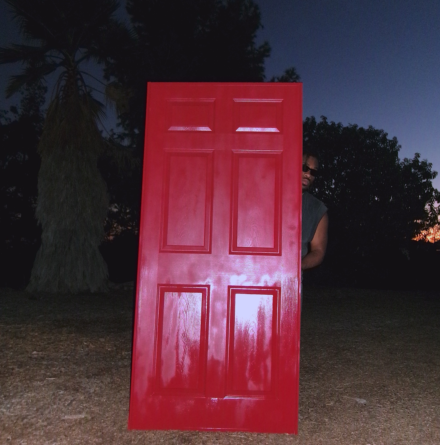 Shalant peeking from behind the red door