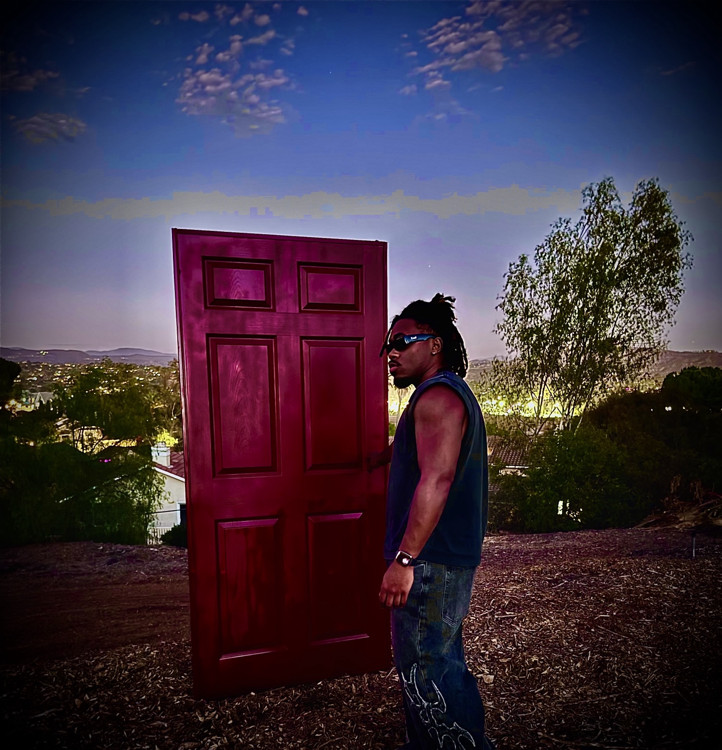 Shalant beside the red door at twilight